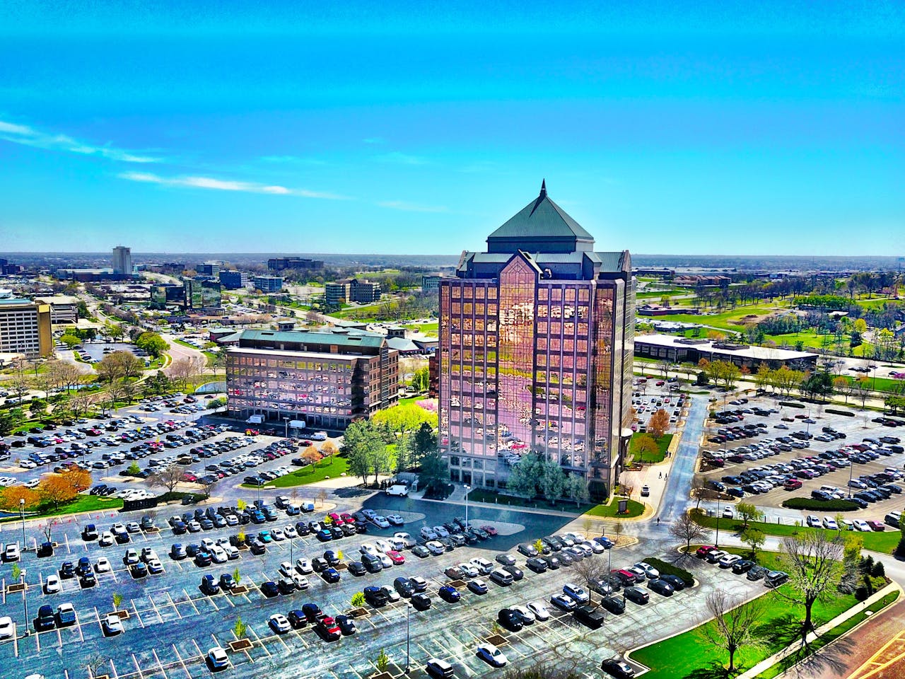 Building Surrounded by Parking Lot Under Clear Day Sky